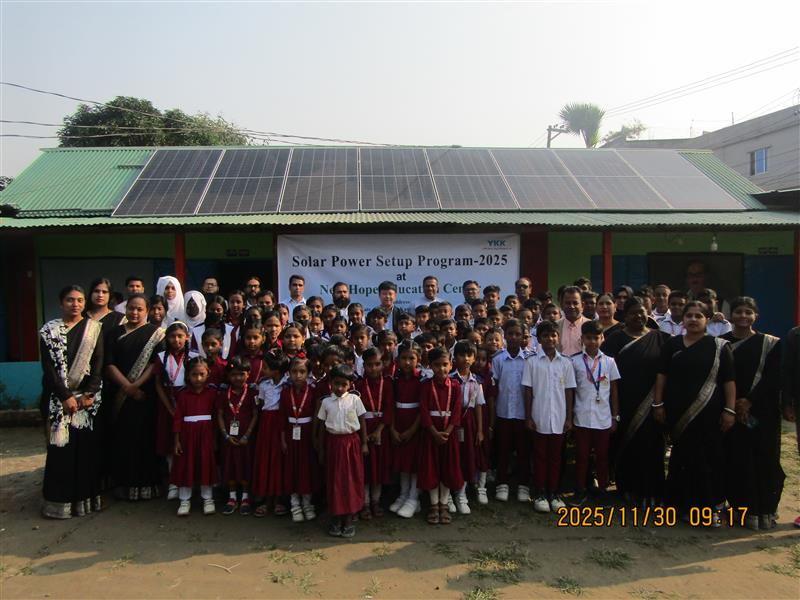 8 group photo in front of solar panels with students