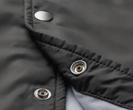 Low-profiled Lightweight Snap snap button on a piece of garment.